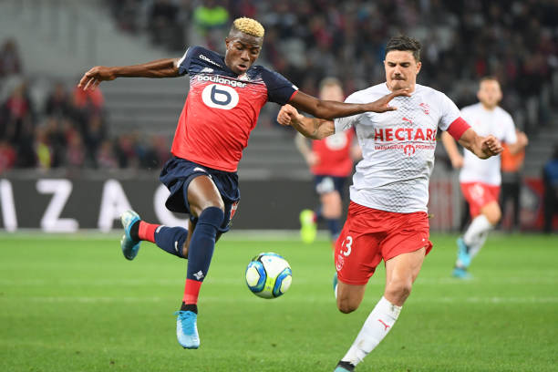 Victor OSIMHEN of Lille and Anthony BRIANCON of Nimes during the Ligue 1 match between Lille OSC and Nimes Olympique at Stade Pierre Mauroy on October 6, 2019 in Lille, France. (Photo by Anthony Dibon/Icon Sport via Getty Images)