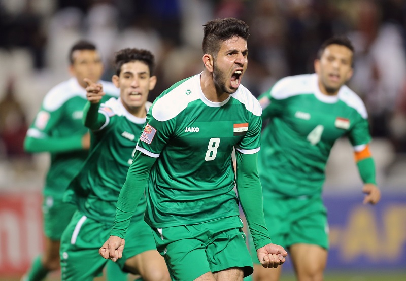 Iraq’s forward Mohanad Abdulraheem Karrar (#8) celebrates scoring his team’s equalising goal during their AFC U23 Championship 3rd place football match between Qatar and Iraq in Doha on January 29, 2016. / AFP PHOTO / Karim JAAFAR